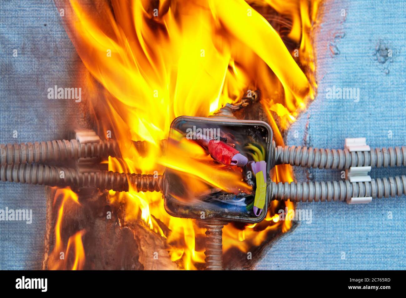 Electric fire caused by a short circuit in home electrical network. Damaged wiring caused overload of power system in house. Burned insulation of the Stock Photo