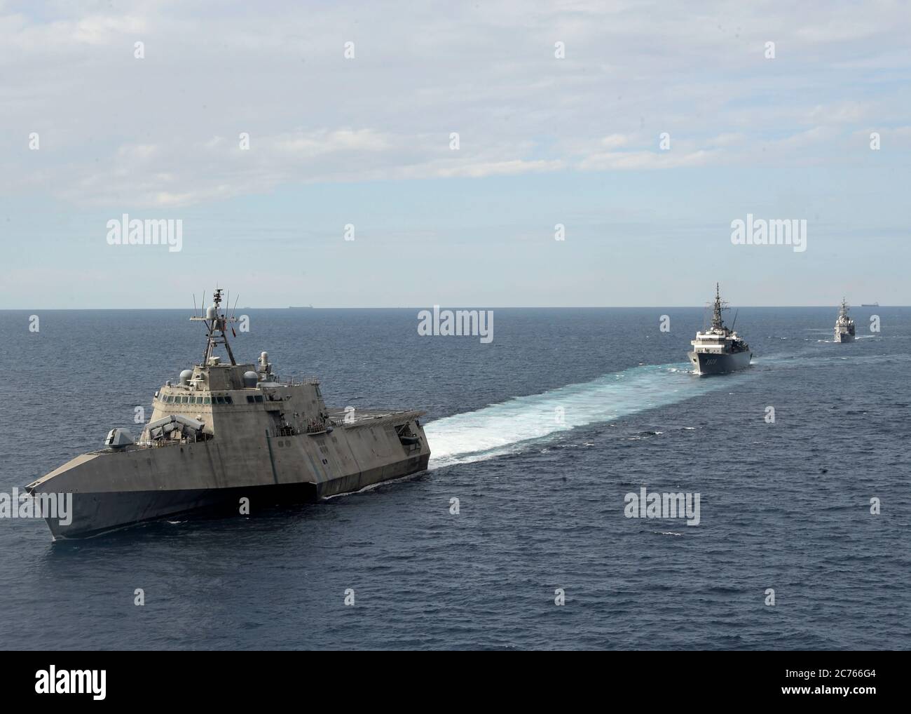 The U.S. Navy Independence-variant littoral combat ship USS Gabrielle Giffords during a joint patrol with the Japan Maritime Self-Defense Kashima class cadet training ship JS Kashima and Force Hatsuyuki-class destroyer JS Shimayuki in International Waters June 23, 2020 in the South China Sea. Stock Photo