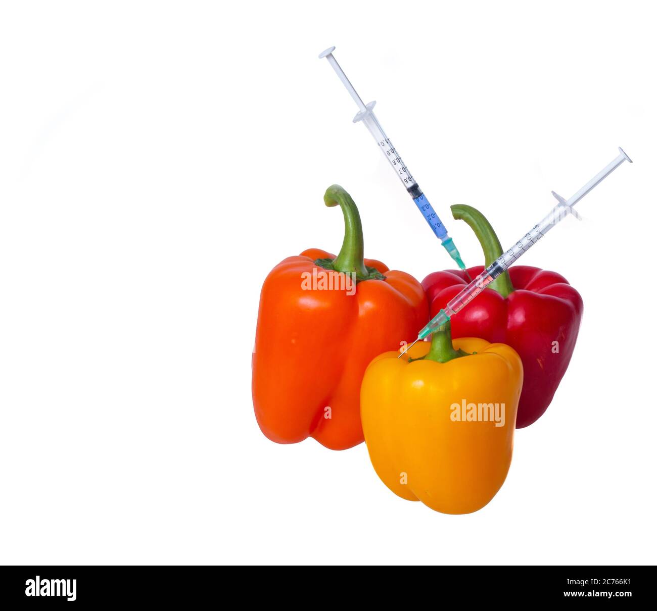 Genetically modified vegetables. GMO food concept. Syringes are stuck in vegetables with chemical additives. Injections into fruits and vegetables. Is Stock Photo