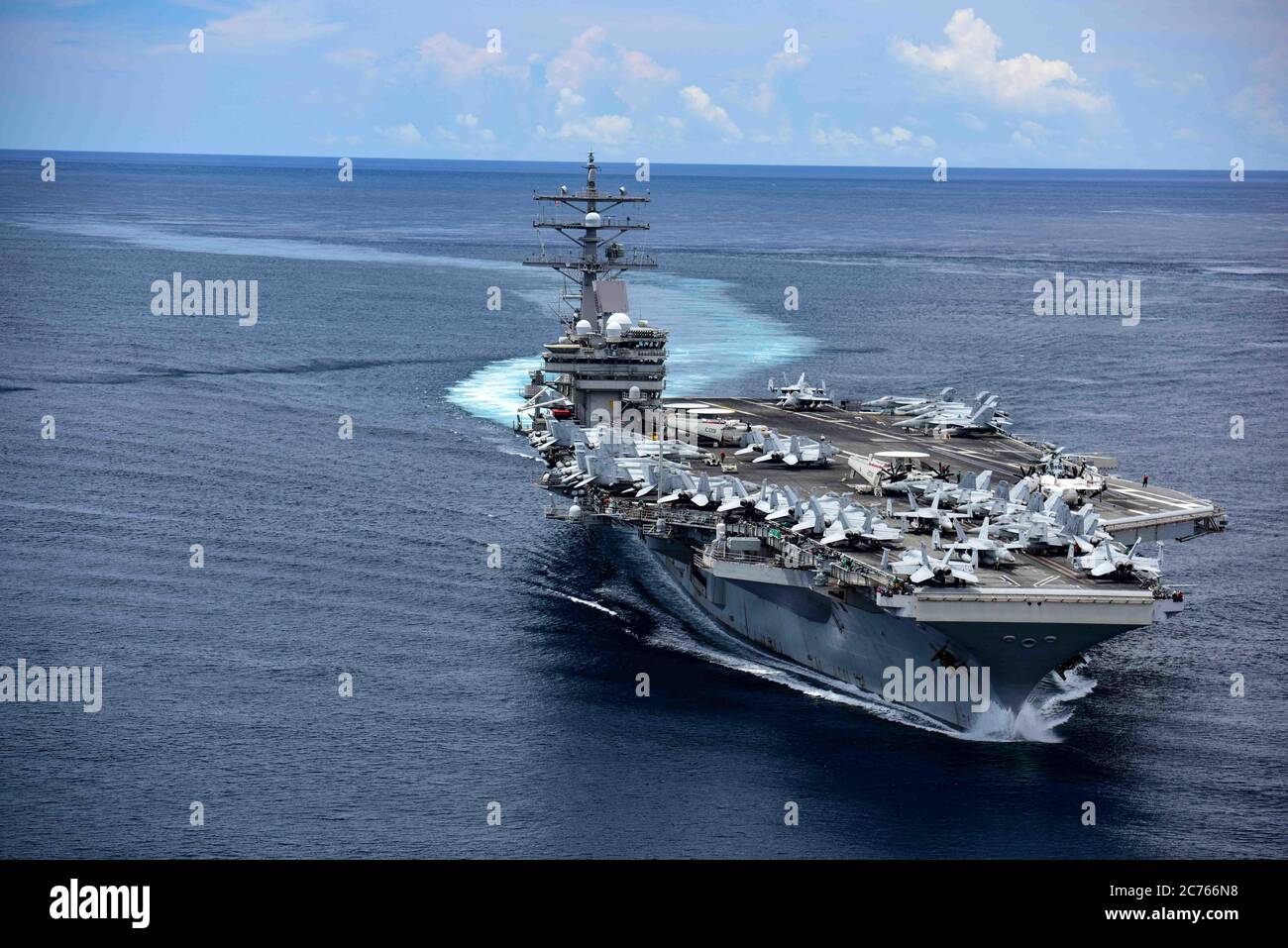 The U.S. Navy Nimitz-class aircraft carrier USS Ronald Reagan sails through the San Bernardino Straits during dual-carrier operations with the USS Nimitz July 3, 2020 in the Philippine Sea. Stock Photo