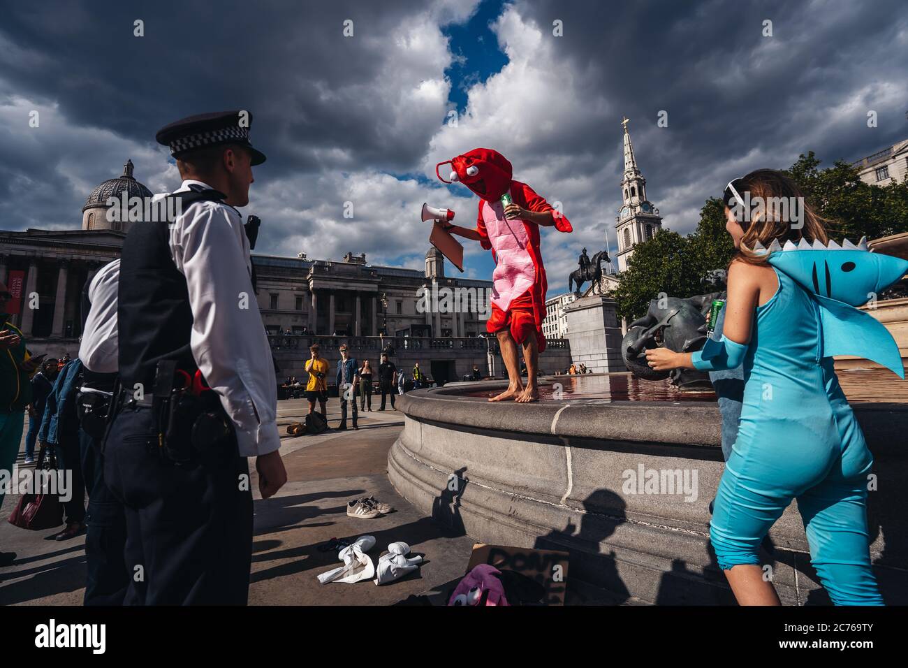 London / UK - 07/11/2020: Police officers having a conversation with protesters after Animal rights group turns fountains red in London's Trafalgar Sq Stock Photo