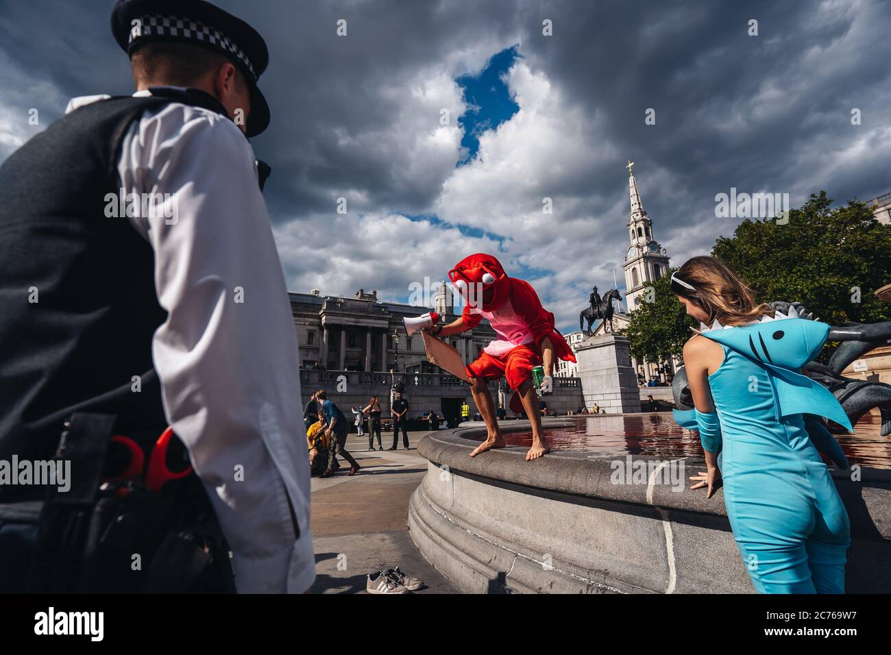 London / UK - 07/11/2020: Police officers having a conversation with protesters after Animal rights group turns fountains red in London's Trafalgar Sq Stock Photo