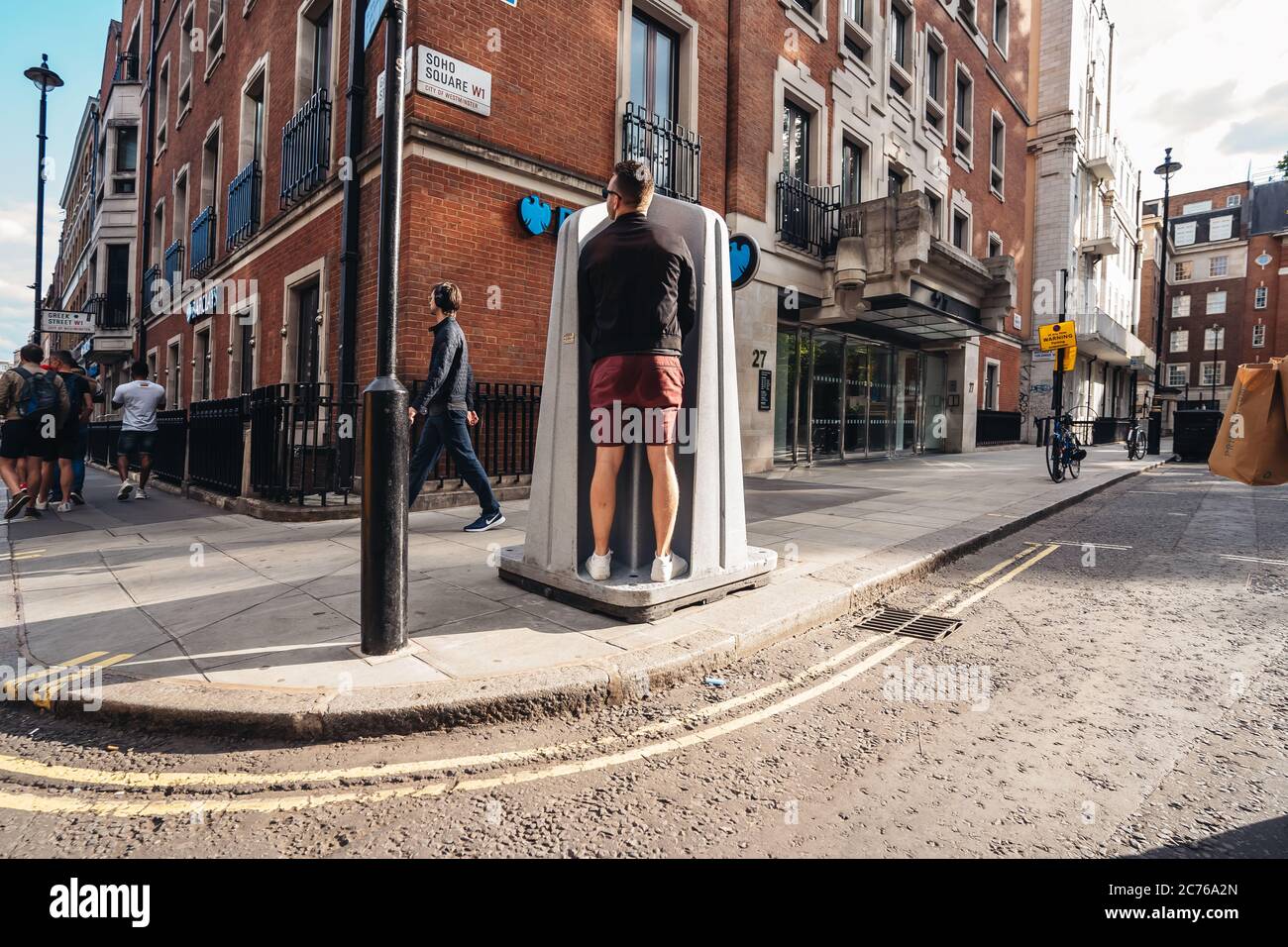 London / UK 07/11/2020 Man using the public pissuar, urinal in Soho