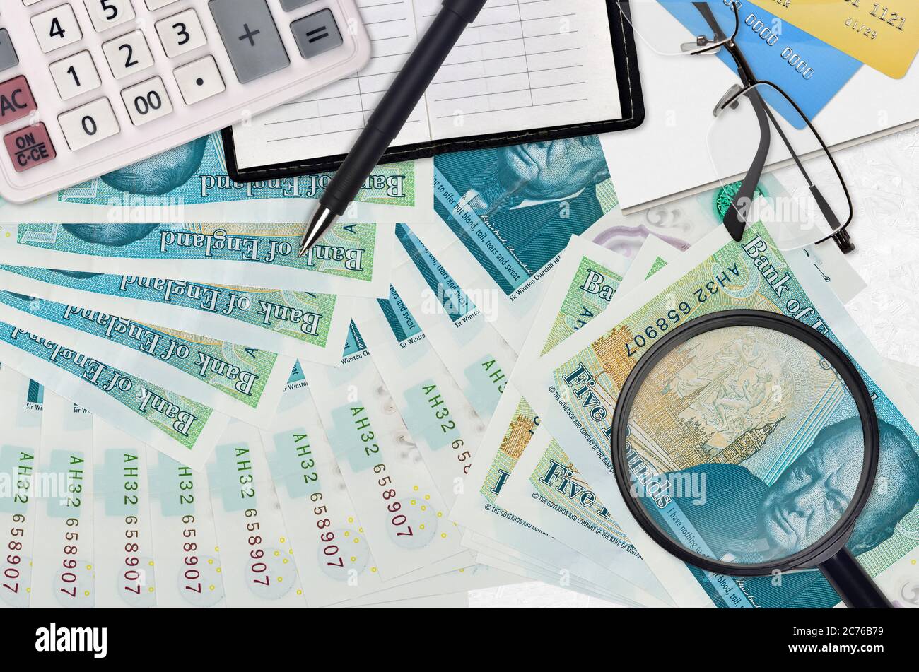5 British pounds bills and calculator with glasses and pen. Tax payment  season concept or investment solutions. Searching a job with high salary  earni Stock Photo - Alamy
