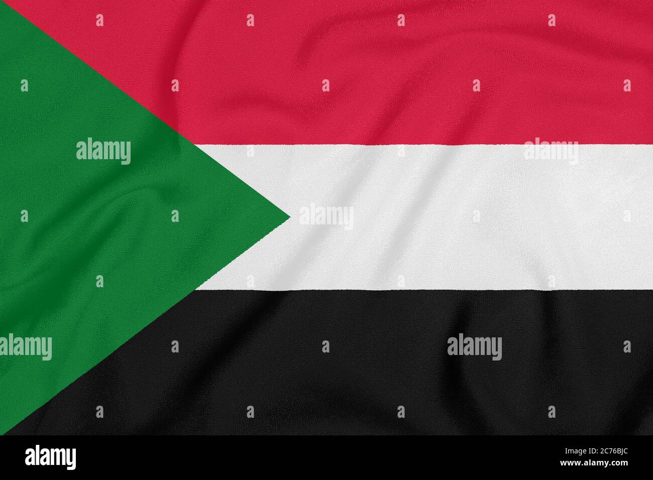 Flag of Sudan on textured fabric. Patriotic symbol Stock Photo