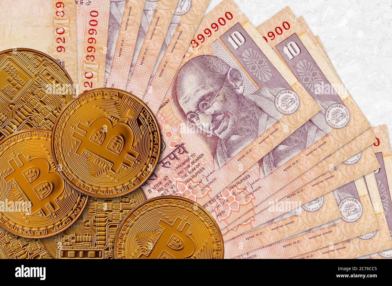 10 Indian rupees bills and golden bitcoins. Cryptocurrency investment  concept. Crypto mining or trading transactions Stock Photo - Alamy