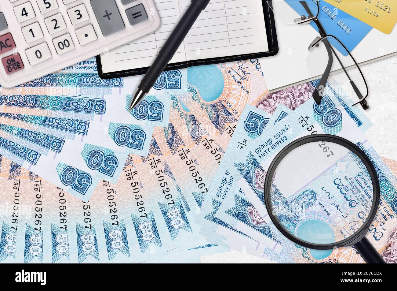 50 Sri Lankan rupees bills and calculator with glasses and pen. Tax payment  season concept or investment solutions. Searching a job with high salary e  Stock Photo - Alamy
