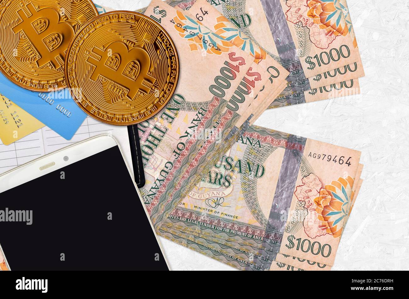 1000 Guyanese dollars bills and golden bitcoins. Cryptocurrency investment  concept. Crypto mining or trading transactions Stock Photo - Alamy