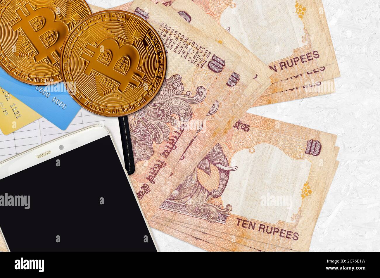 10 Indian rupees bills and golden bitcoins with smartphone and credit  cards. Cryptocurrency investment concept. Crypto mining or trading  transactions Stock Photo - Alamy