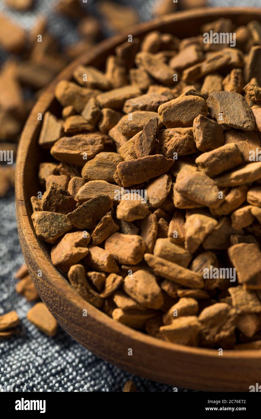 Raw Organic Cassia Cinnamon Chips in a Bowl Stock Photo