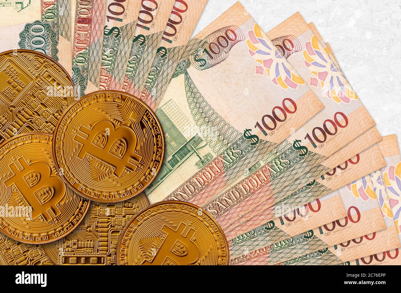 1000 Guyanese dollars bills and golden bitcoins. Cryptocurrency investment  concept. Crypto mining or trading transactions Stock Photo - Alamy