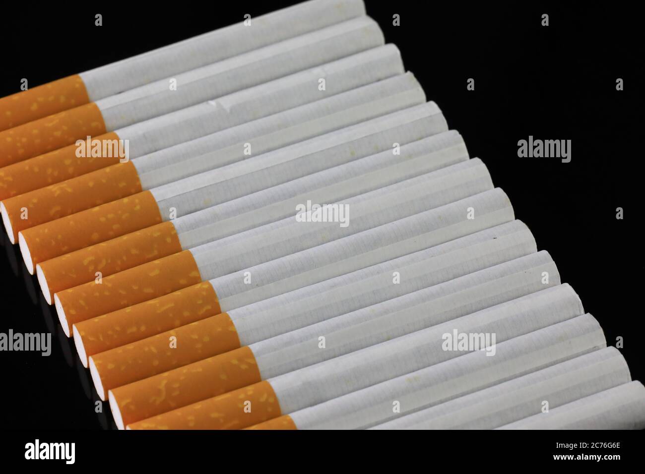 smoking 2 cigarettes in a row Row of smoking cigarettes Stock Photo