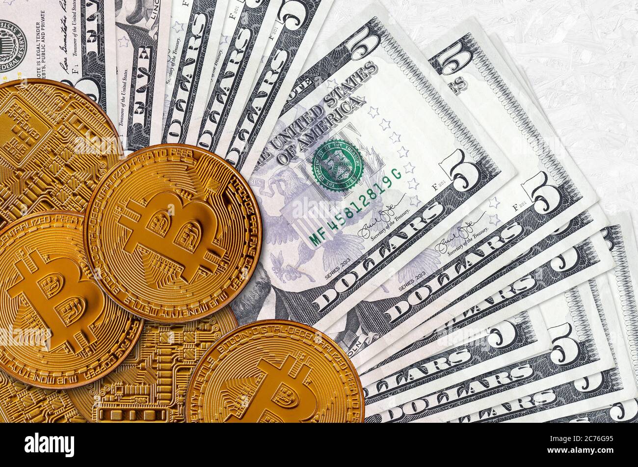 5 US dollars bills and golden bitcoins. Cryptocurrency investment concept.  Crypto mining or trading transactions Stock Photo - Alamy