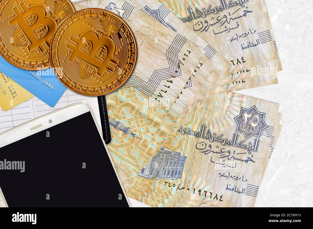 25 Egyptian piastres bills and golden bitcoins with smartphone and credit  cards. Cryptocurrency investment concept. Crypto mining or trading  transacti Stock Photo - Alamy