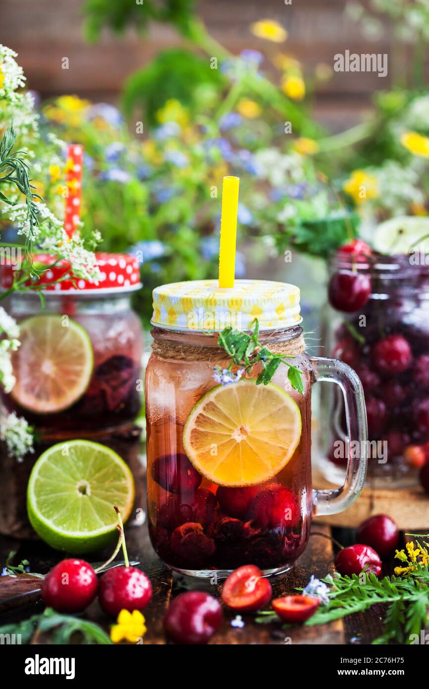 Healthy homemade cold lemonade with fresh berries and fruits in mason jar Stock Photo