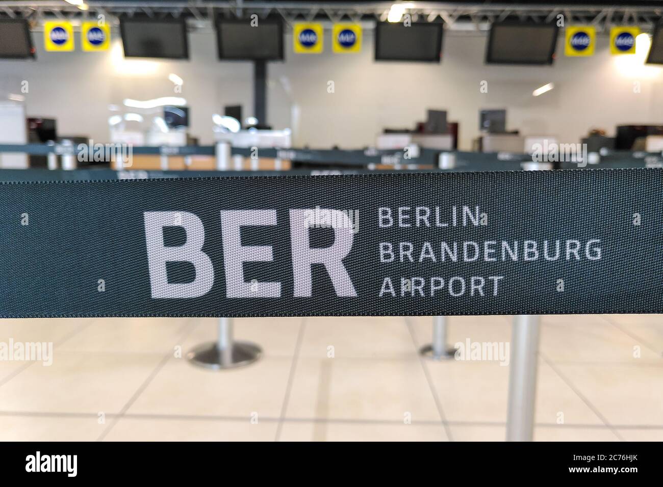 Barrier tape for BER Berlin Brandenburg airport used at Schönefeld airport at the deserted check-in desks during the coronavirus crisis in Germany. Stock Photo