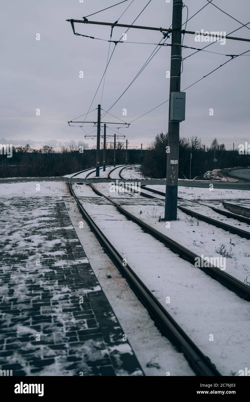 Train rails in winter season. Beautiful landscape of countryside. Rail track laid through forest. Stock Photo