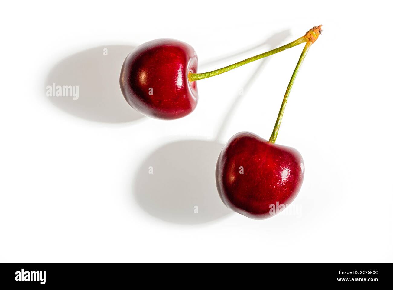 Sweet cherries with a shadow on a white background. Top view. Stock Photo