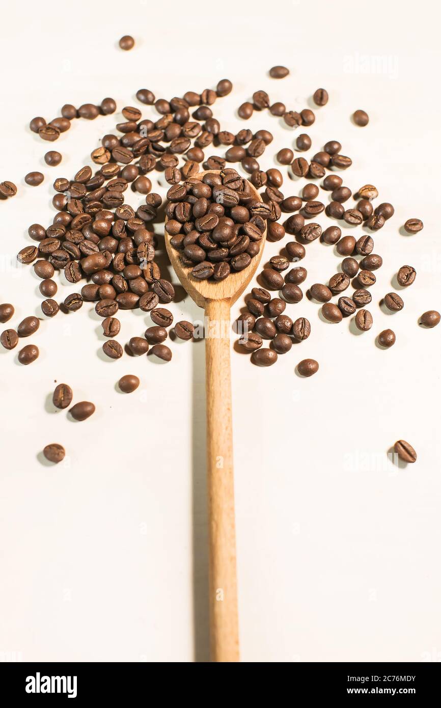 coffee beans and wooden spoon isolated on white background Stock Photo ...