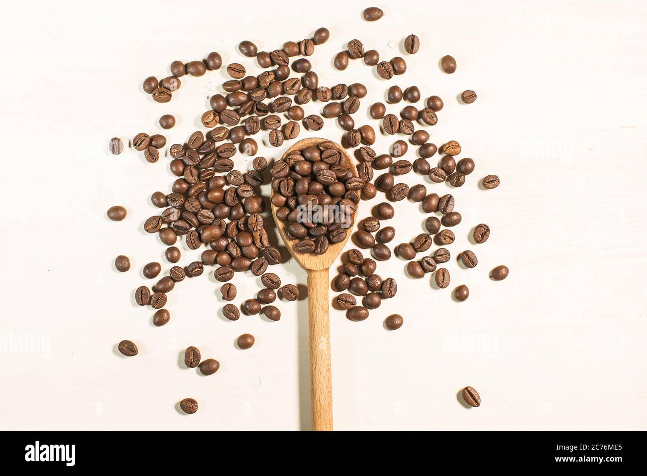 coffee beans and wooden spoon isolated on white background Stock Photo ...