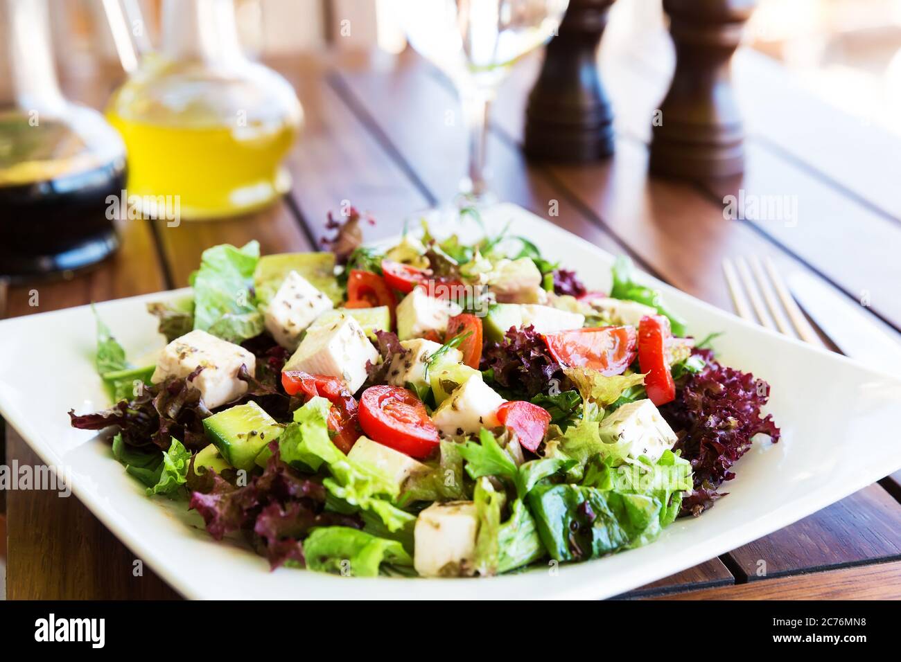 Greek Mediterranean salad with feta cheese, tomatoes and peppers. Mediterranean salad. Mediterranean cuisine. Greek cuisine. Stock Photo