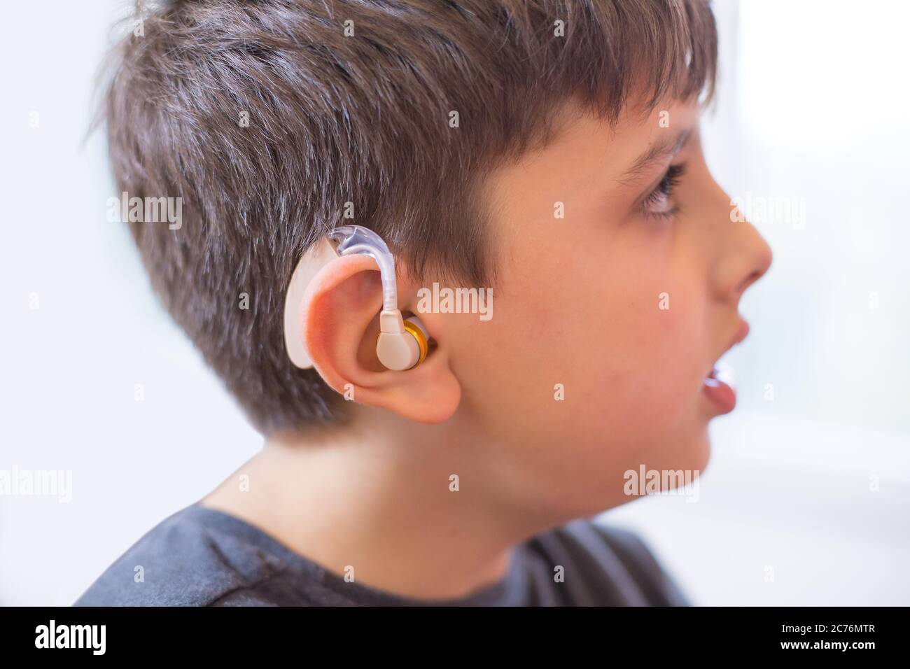 young boy using hearing aid Stock Photo