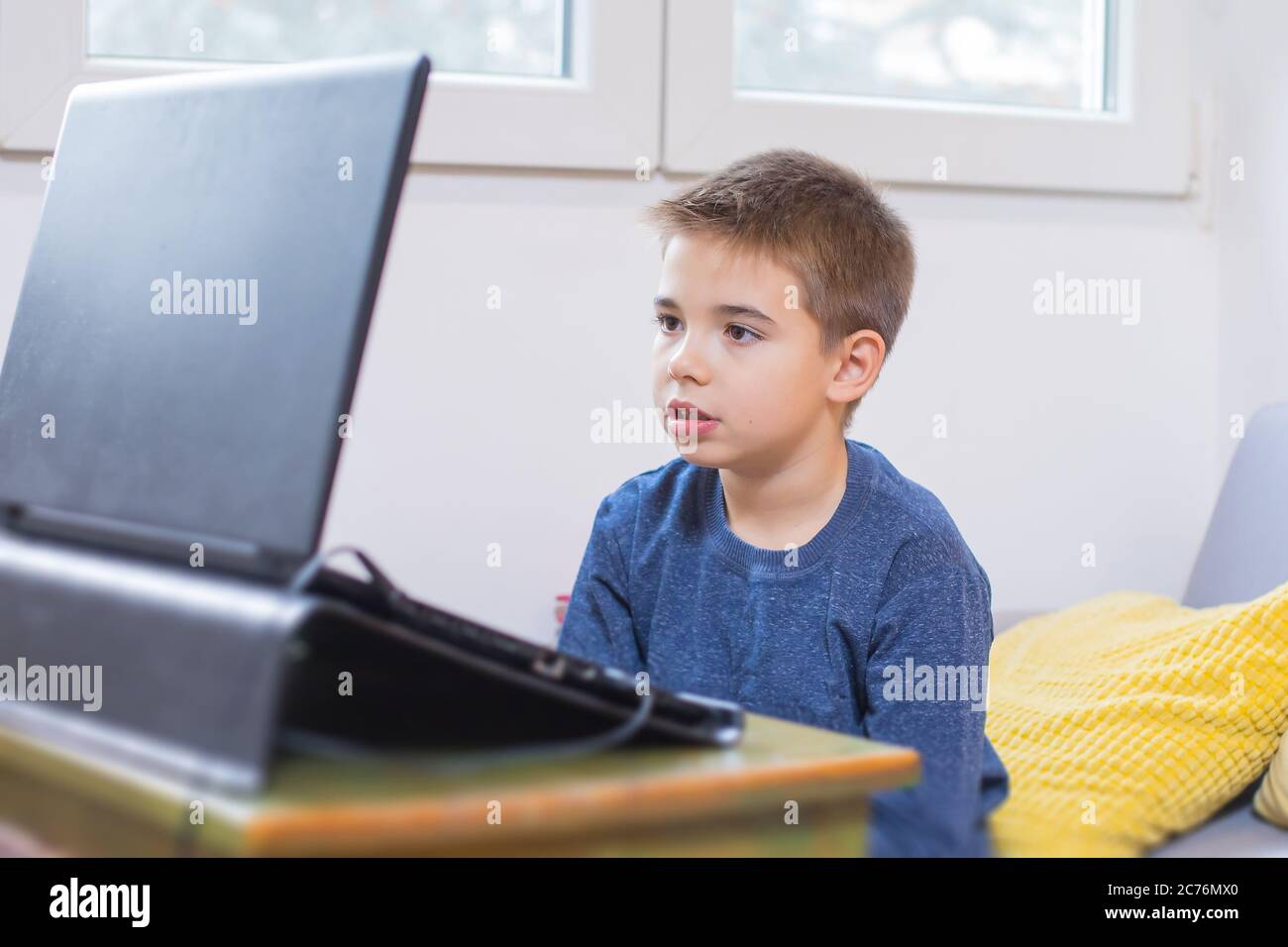 young boy using computer at home Stock Photo