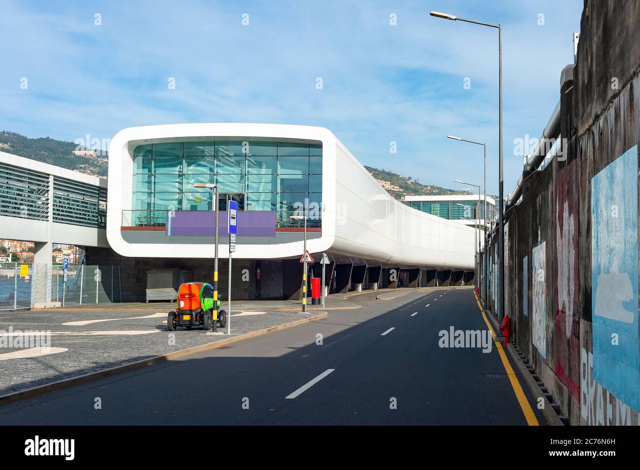 Airport terminal building of modern architecture, passage, electromobile and asphalt entry road, Funchal, Madeira island, Portugal Stock Photo