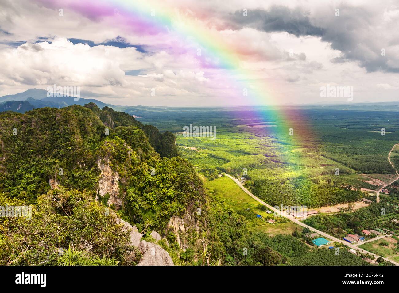 Beautiful landscape with cloudy blue sky and rainbow Stock Photo - Alamy