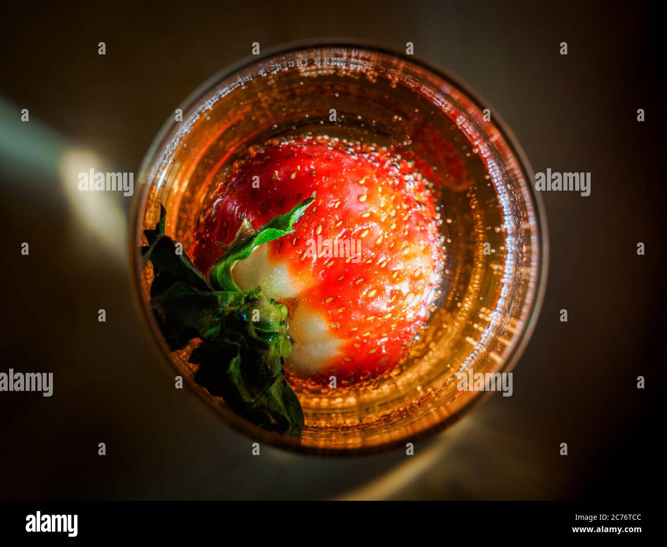 Strawberry in glass of sparkling wine from the top Stock Photo
