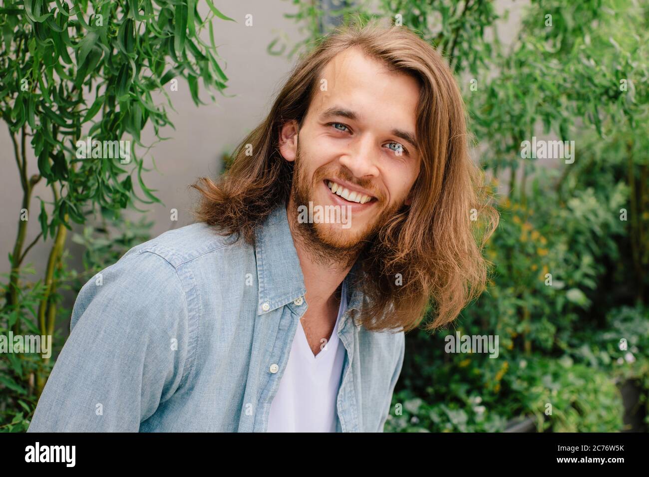 Portrait of a handsome man with long hair Stock Photo