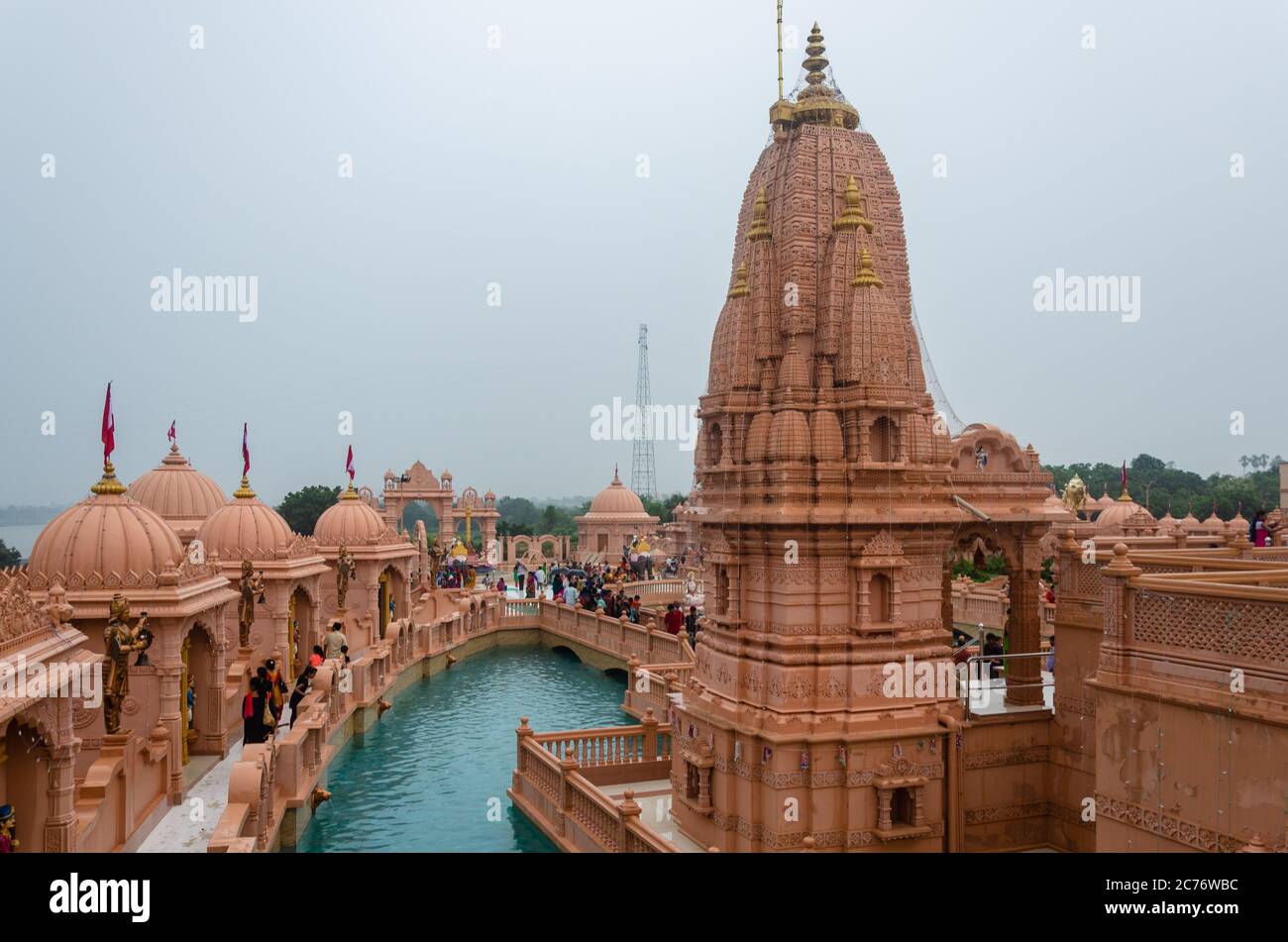 Sandstone mandaps surrounding the artificial pond at Nilkanth Dham Swaminarayan Temple, Poicha, Gujarat, India Stock Photo