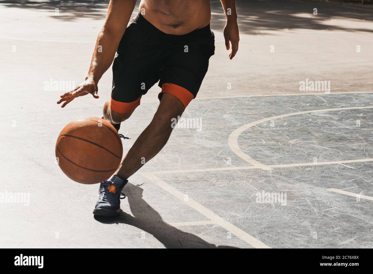 unrecognizable young man playing basketball Stock Photo
