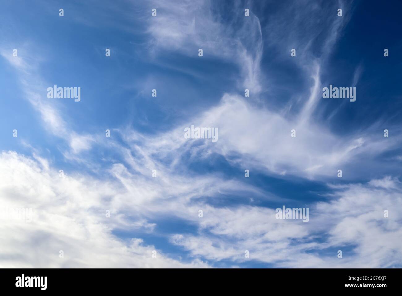 Stunning cirrus cloud formation panorama in a deep blue summer sky seen ...