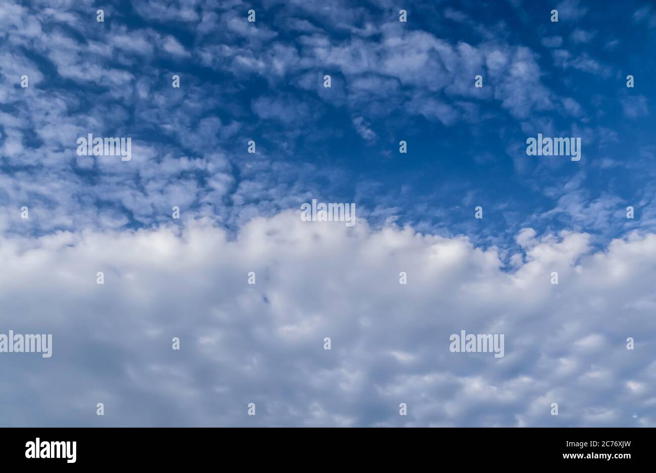 Stunning cirrus cloud formation panorama in a deep blue summer sky seen ...