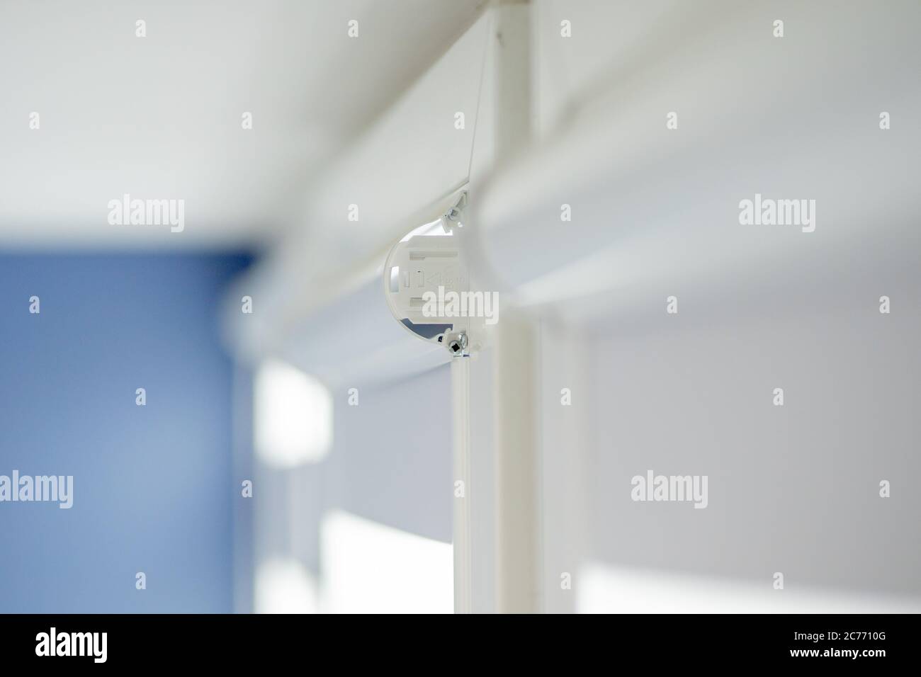 Man installing cassette roller blinds on windows Stock Photo