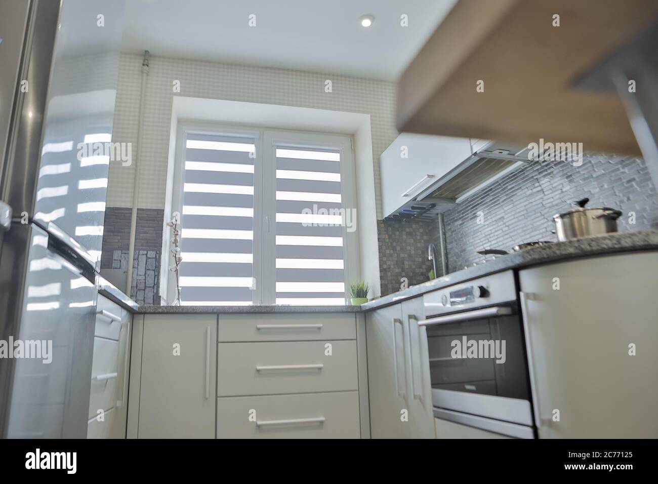 Modern Gray Kitchen Features Gray Flat Front Cabinets Paired With Gray Countertops And A Glossy Gray Linear Tile Backsplash Stock Photo Alamy