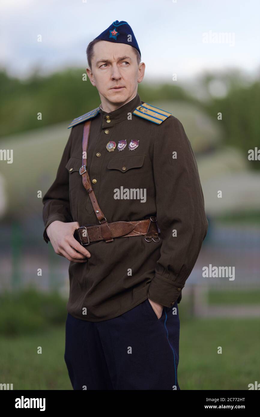 A young adult male pilot in the uniform of pilots of the Soviet Army of the  World War II period. Military uniform with shoulder straps of a major and  Stock Photo -
