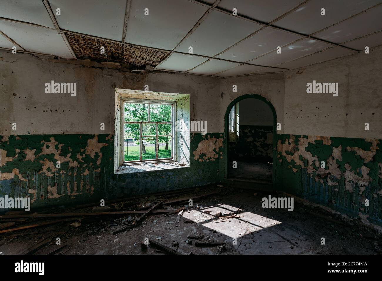 Abandoned house interior, dirty room, rotten peeled walls Stock Photo