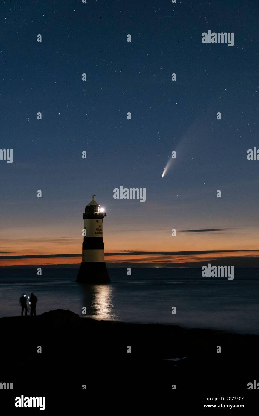 Comet NEOWISE and The Night Sky above Trwyn Du Lighthouse or Penmon Point Lighthouse, Penmon, Anglesey, North Wales, UK Stock Photo