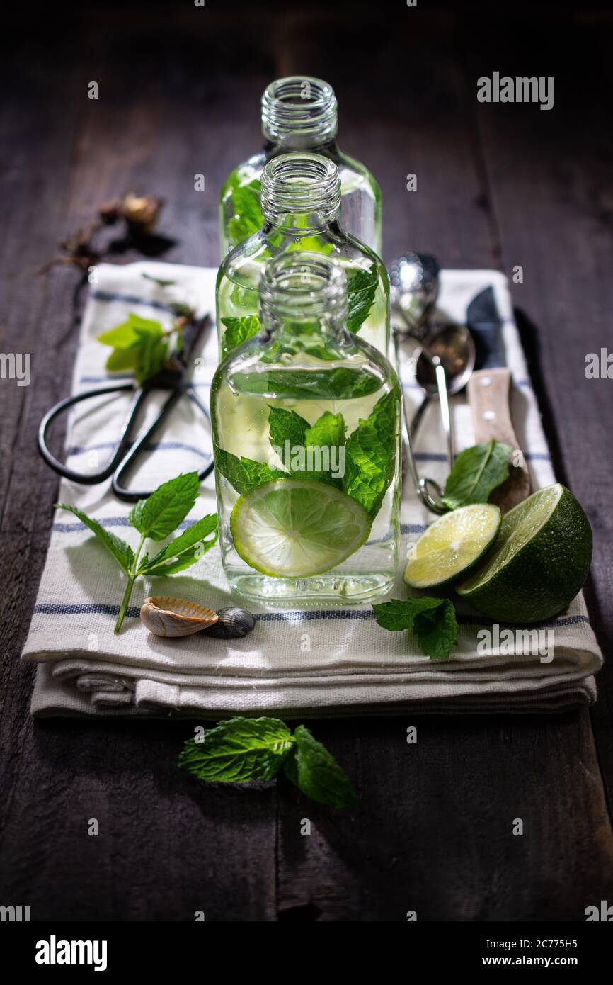 Mint drink in bottles.refreshing lime water.Healthy food and sweets.Country style. Stock Photo