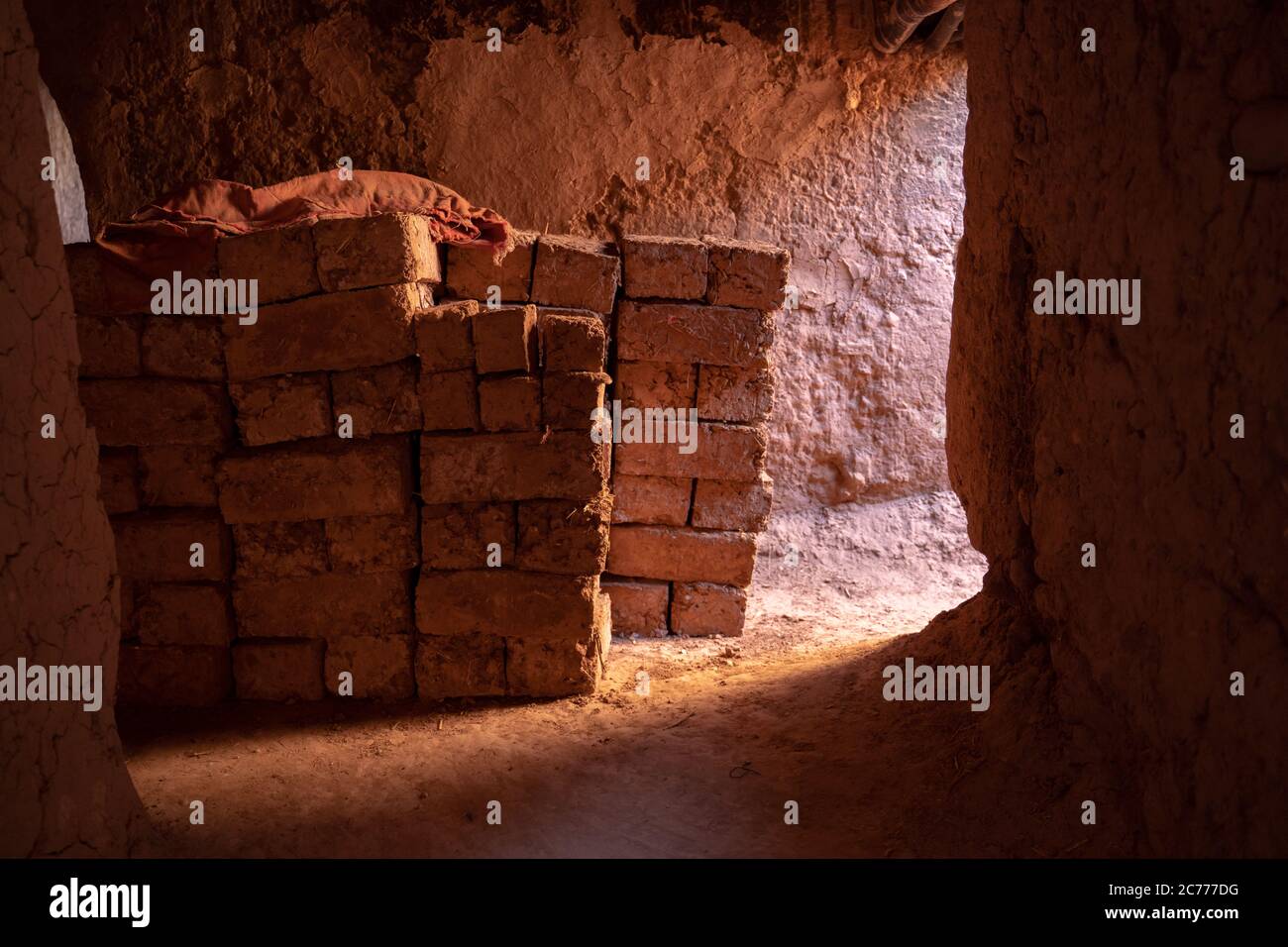 Bricks stacked in old cave Stock Photo