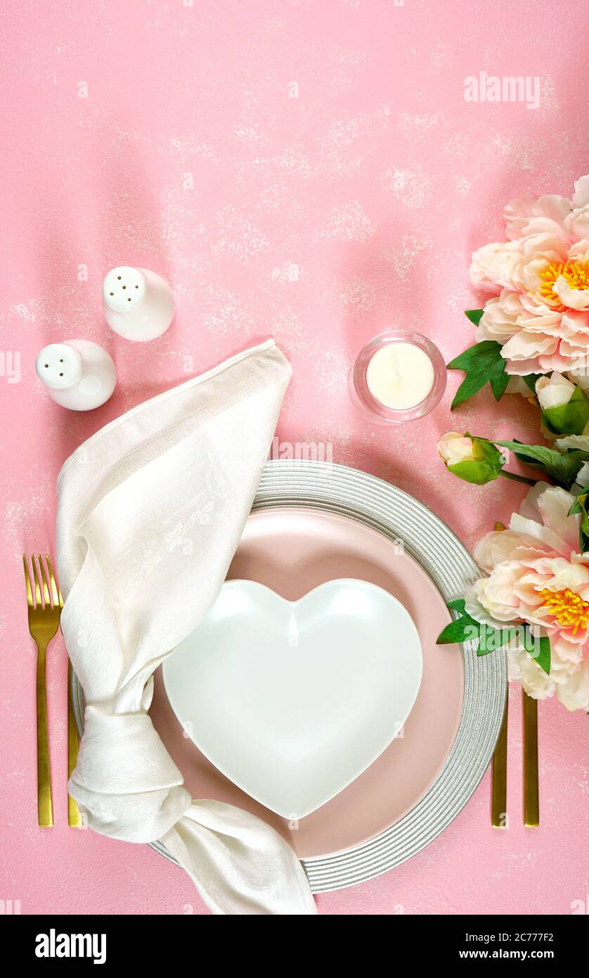 Pink aesthetic elegant fine china events table place setting overhead for weddings, birthday, Christmas, Thanksgiving or Valentine's Day. Top view fla Stock Photo