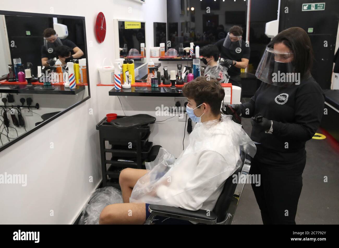 Barber Margaret McGillivray with customer Mitchell Wildman in the