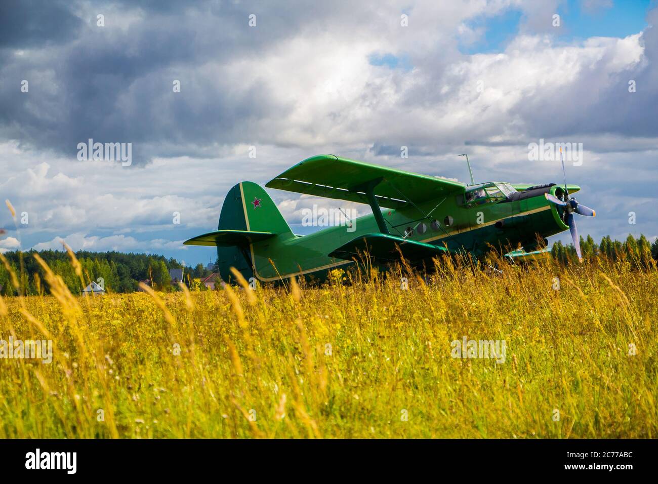 Vintage aircraft preparing for take-off on the background of a stormy sky Stock Photo