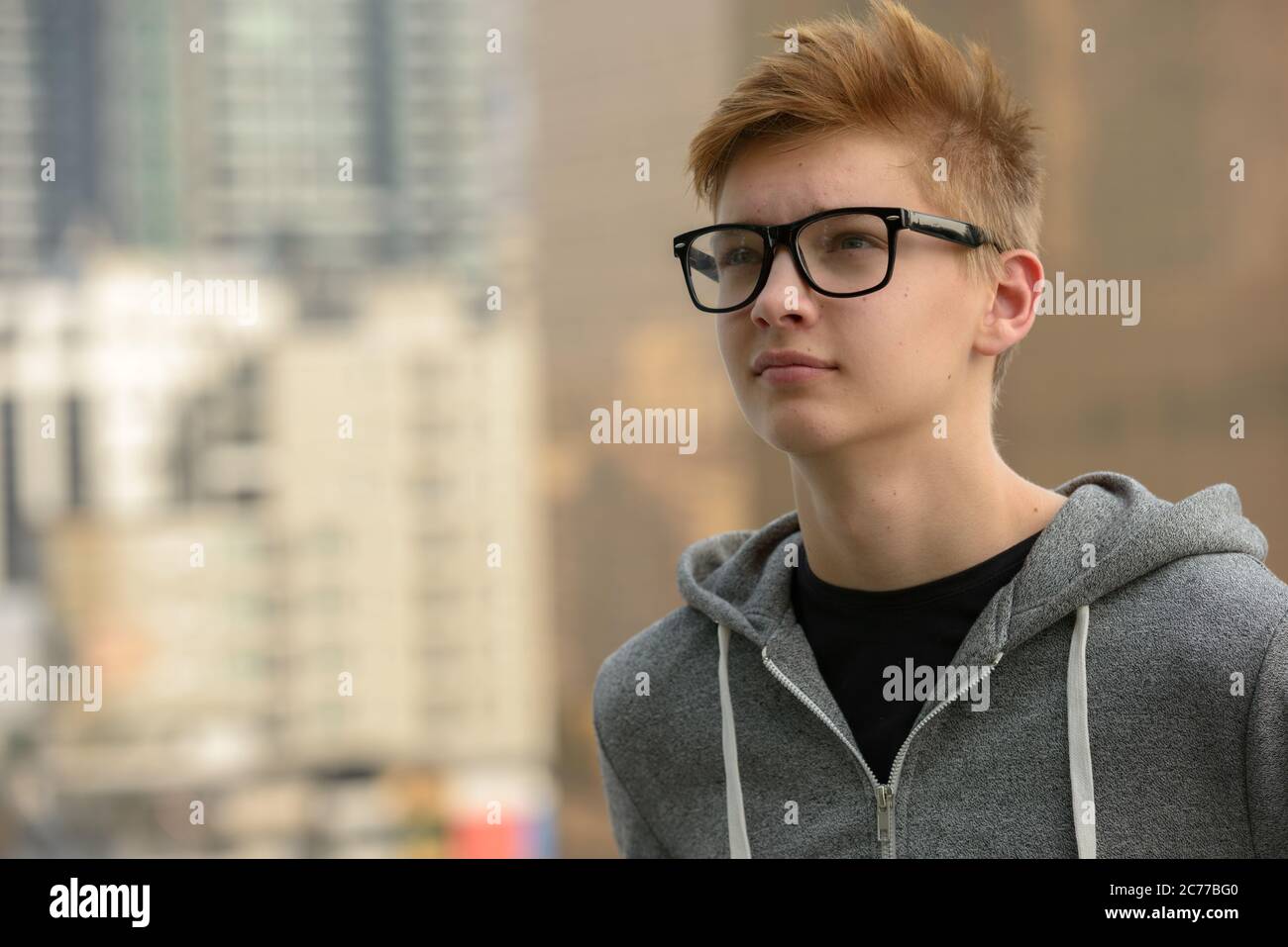 Young handsome teenage boy against view of the city outdoors Stock ...