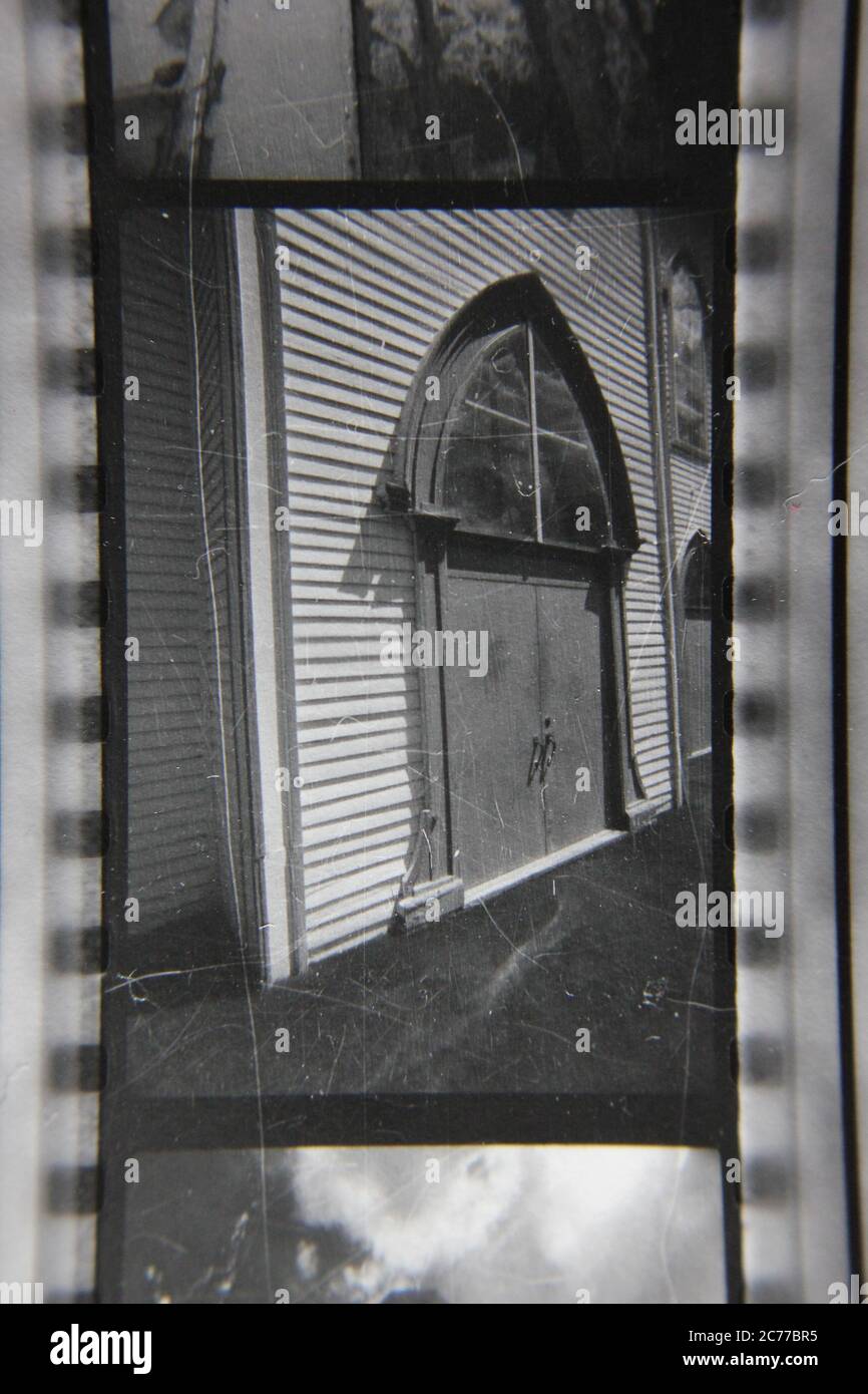 Fine 70s vintage contact print black and white photography of a simple wooden church in a rural area. Stock Photo