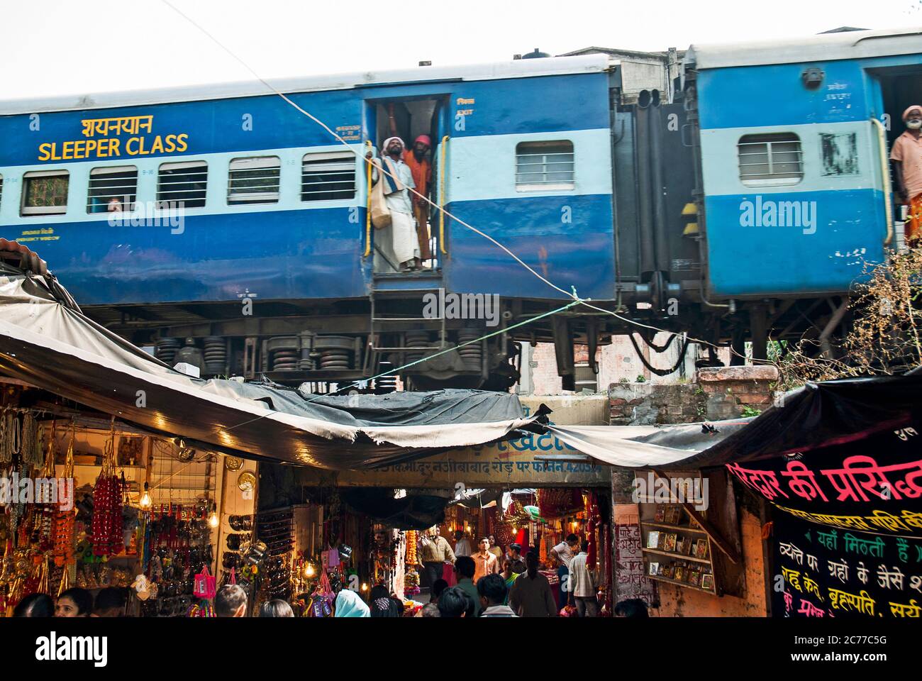 Railway train passing over a bazaar in the pilgrimage town of Haridwar on the Ganges, Uttarakhand, India Stock Photo