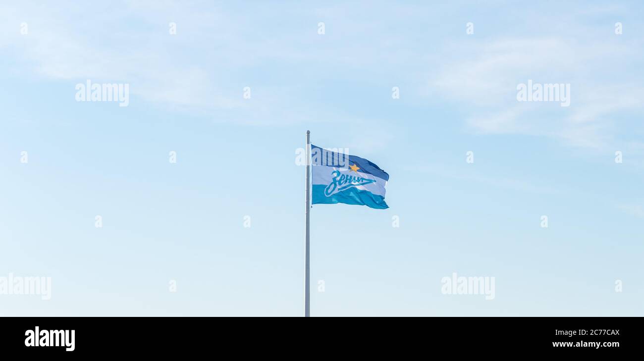 Saint Petersburg, Russia - July 14, 2020: a flag of football club Zenit waves against the blue sky. Stock Photo