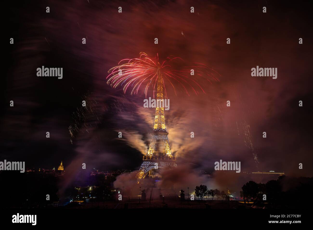 Paris, France. 14th July, 2020. Fireworks explode near the Eiffel Tower ...